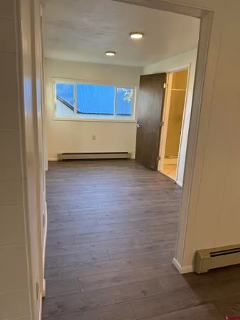 view of small space with wooden floor and wall painting