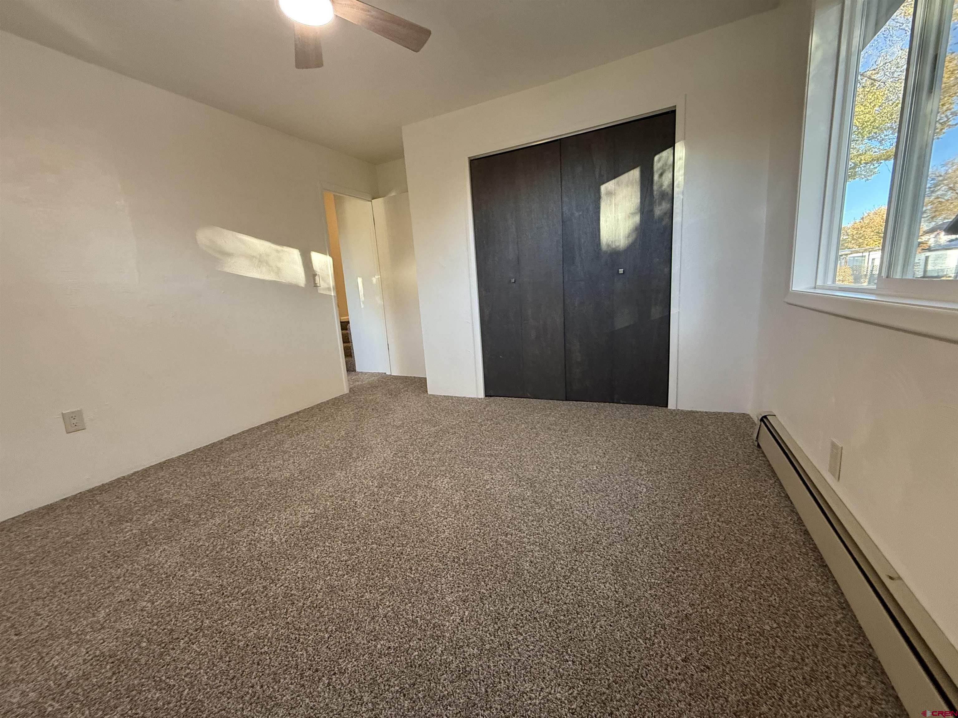 460 Fox Street Nucla, CO 81424 - Photo 30 of 33 an empty room with windows and closet