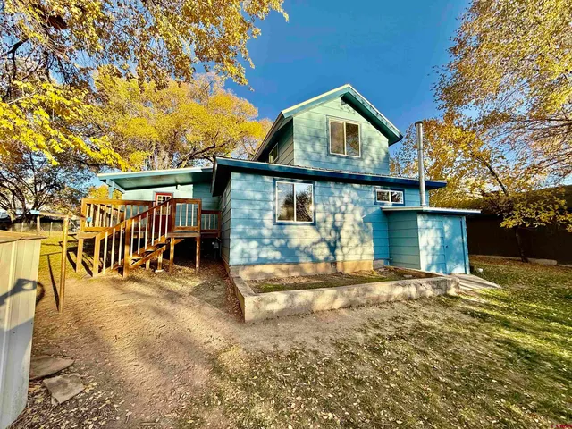 a view of a livingroom with wooden floor and a fireplace