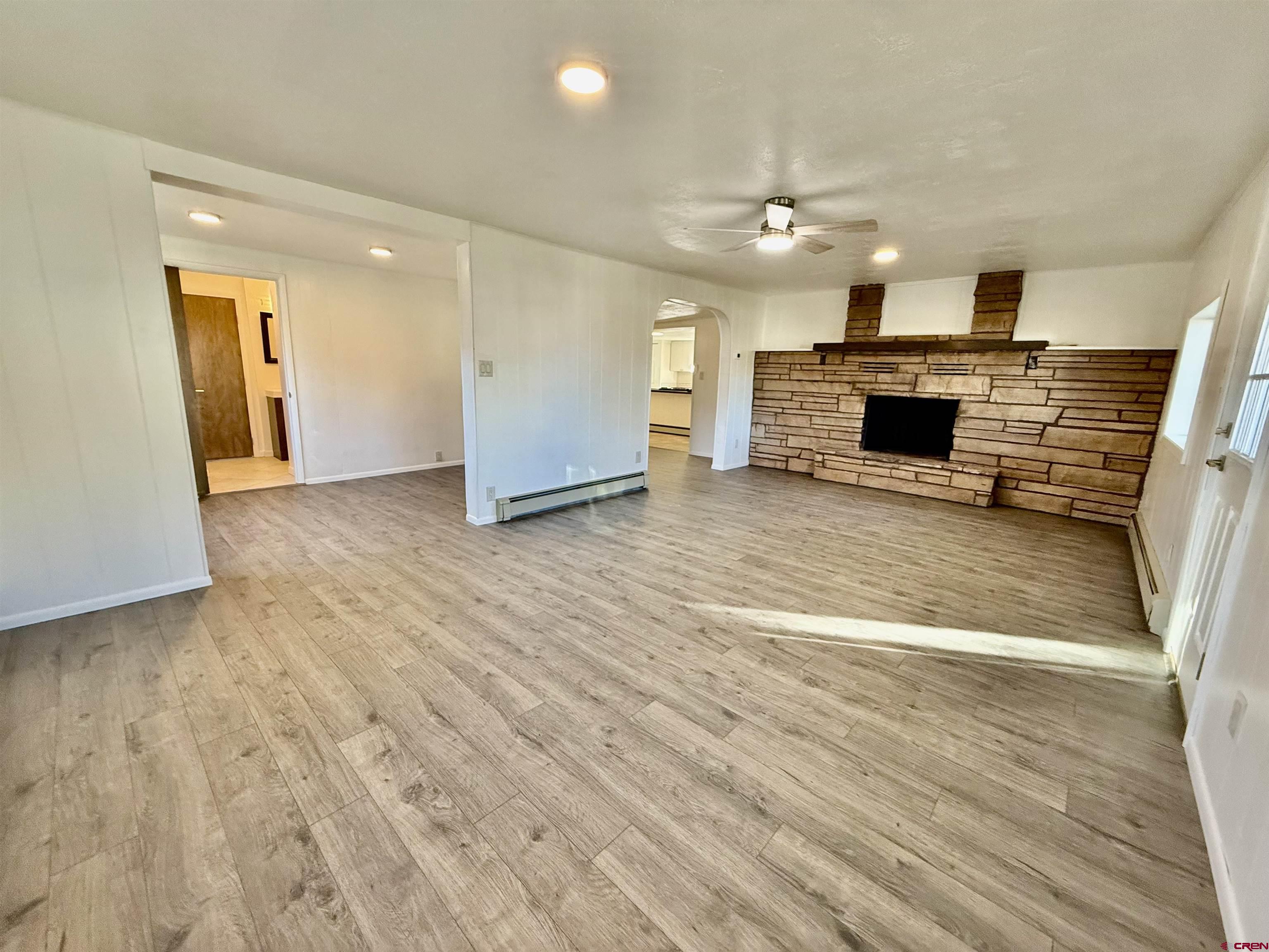 460 Fox Street Nucla, CO 81424 - Photo 10 of 33 a view of empty room with wooden floor and fireplace
