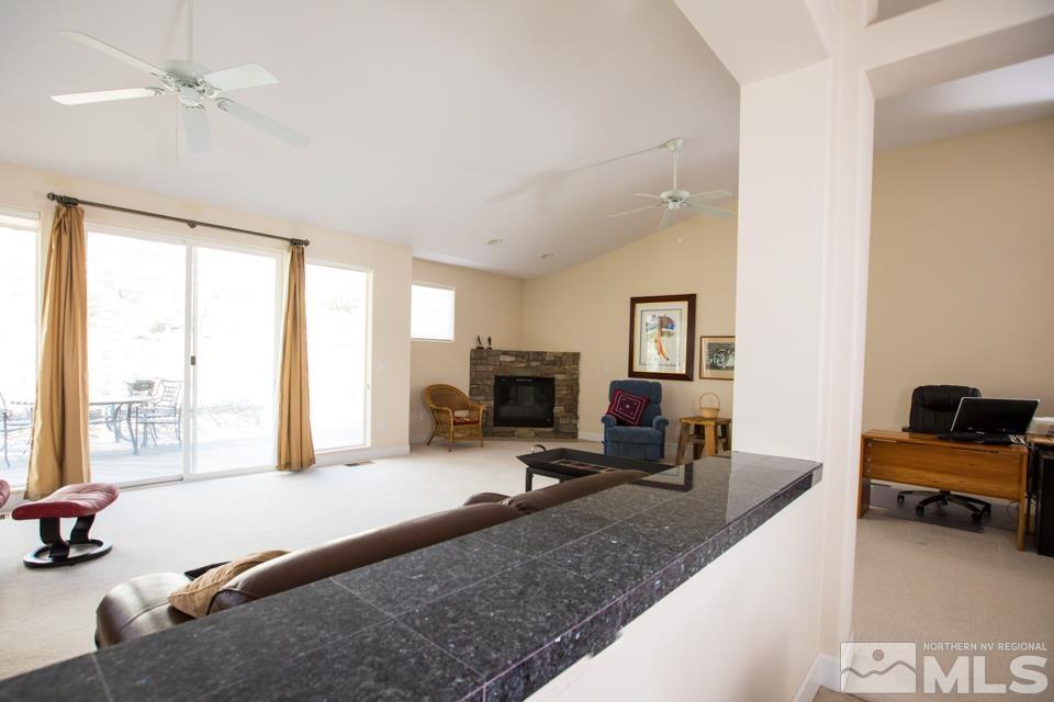 2456 Genoa Meadows Circle Genoa, NV 89411 - Photo 19 of 24 a living room with furniture and a flat screen tv