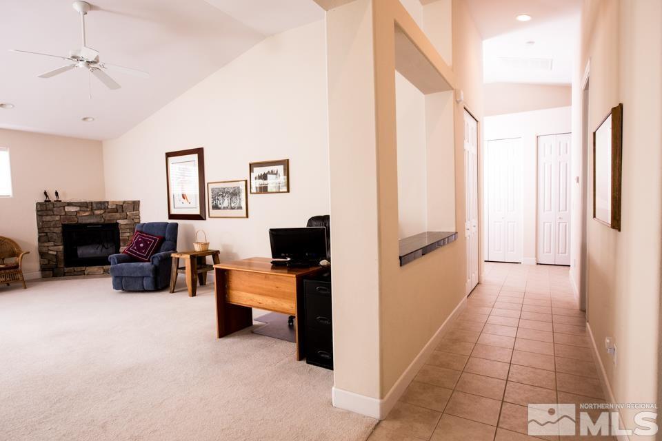 2456 Genoa Meadows Circle Genoa, NV 89411 - Photo 2 of 24 a living room with furniture and a fireplace