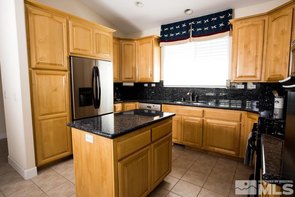 2456 Genoa Meadows Circle Genoa, NV 89411 - Photo 22 of 24 a kitchen with granite countertop a sink a counter top space and stainless steel appliances