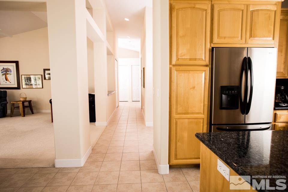 2456 Genoa Meadows Circle Genoa, NV 89411 - Photo 24 of 24 a kitchen with stainless steel appliances granite countertop a refrigerator and a stove