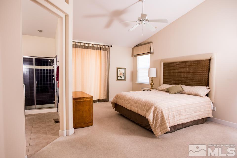 2456 Genoa Meadows Circle Genoa, NV 89411 - Photo 7 of 24 a bedroom with a bed and a chandelier