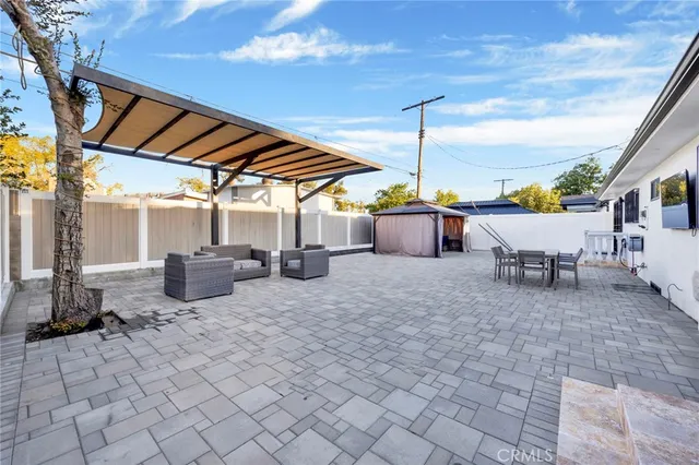 a view of a patio with table and chairs