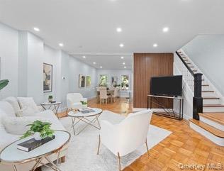 8563 98th Street Queens, NY 11421 - Photo 13 of 16 Living room featuring stairway and recessed lighting