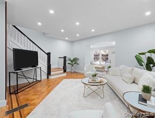 8563 98th Street Queens, NY 11421 - Photo 15 of 16 Living area featuring stairway and recessed lighting