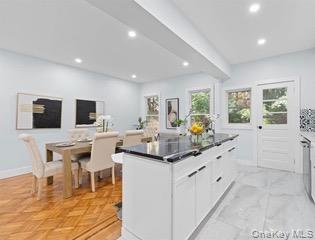 8563 98th Street Queens, NY 11421 - Photo 2 of 16 Kitchen with white cabinetry, recessed lighting, a center island, and beamed ceiling