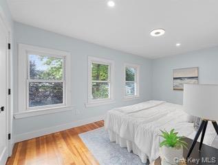 8563 98th Street Queens, NY 11421 - Photo 4 of 16 Bedroom with multiple windows, light wood-type flooring, and recessed lighting