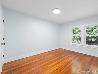 8563 98th Street Queens, NY 11421 - Photo 5 of 16 Spare room featuring baseboards and hardwood / wood-style flooring