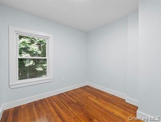 8563 98th Street Queens, NY 11421 - Photo 10 of 16 Empty room featuring wood-type flooring and baseboards