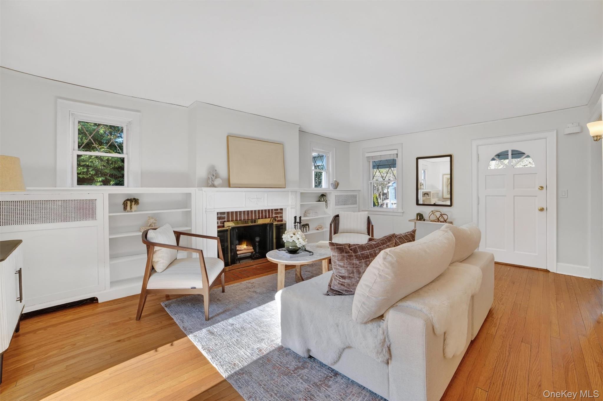 404 Bronxville Road Bronxville, NY 10708 - Photo 12 of 43 a living room with furniture a fireplace and a table