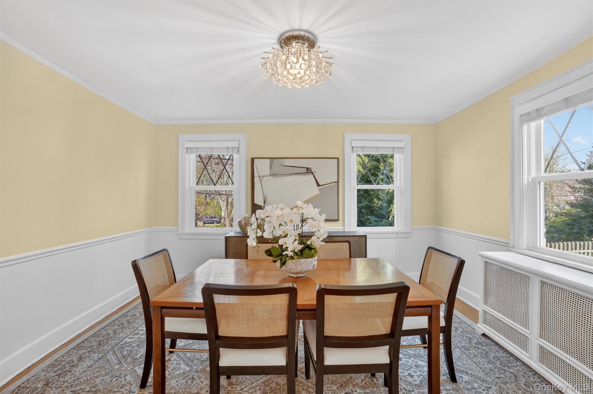404 Bronxville Road Bronxville, NY 10708 - Photo 18 of 43 a dining room with furniture a window and a chandelier