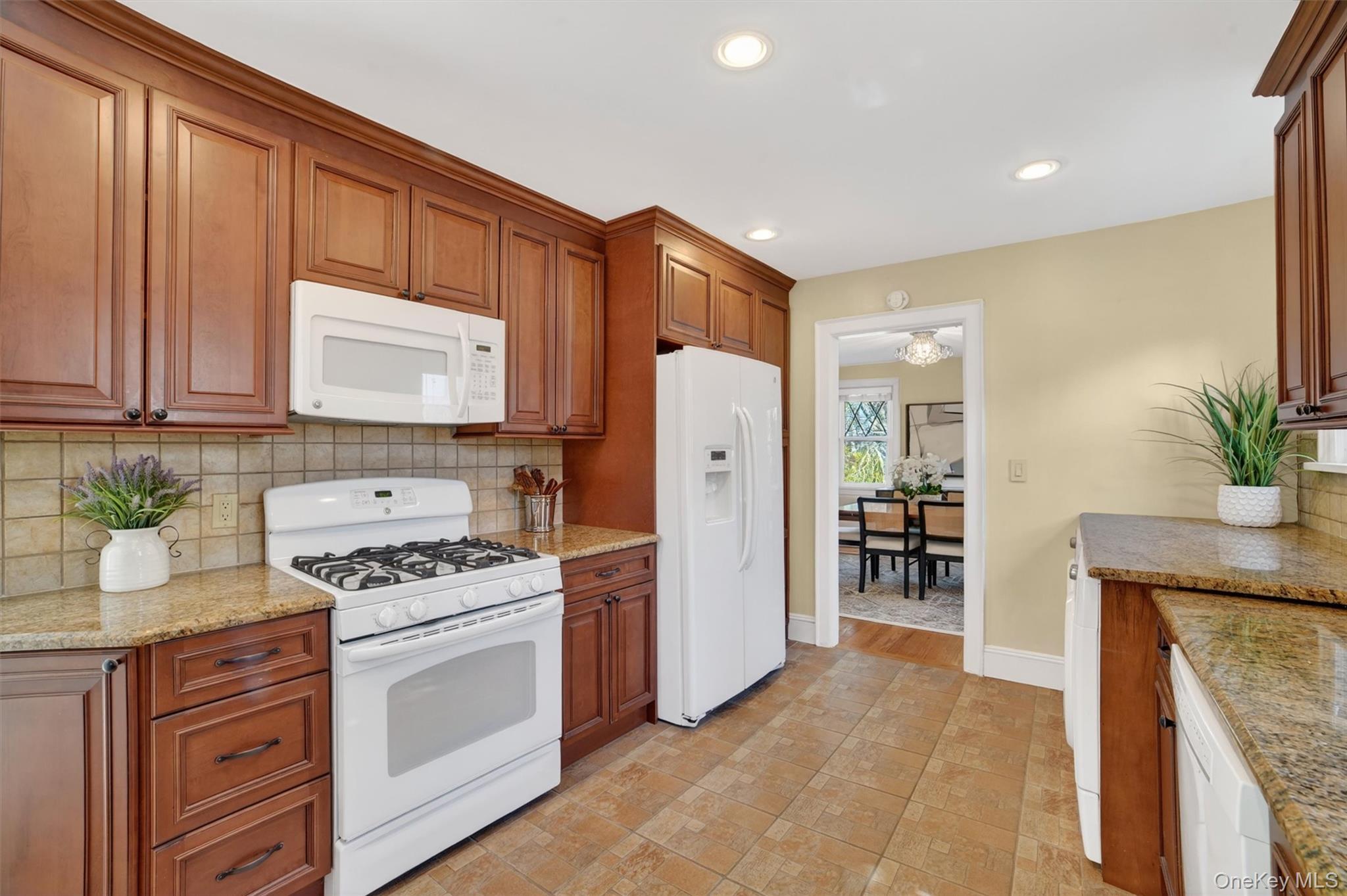 404 Bronxville Road Bronxville, NY 10708 - Photo 21 of 43 a kitchen with stainless steel appliances a refrigerator a stove a sink and a counter space