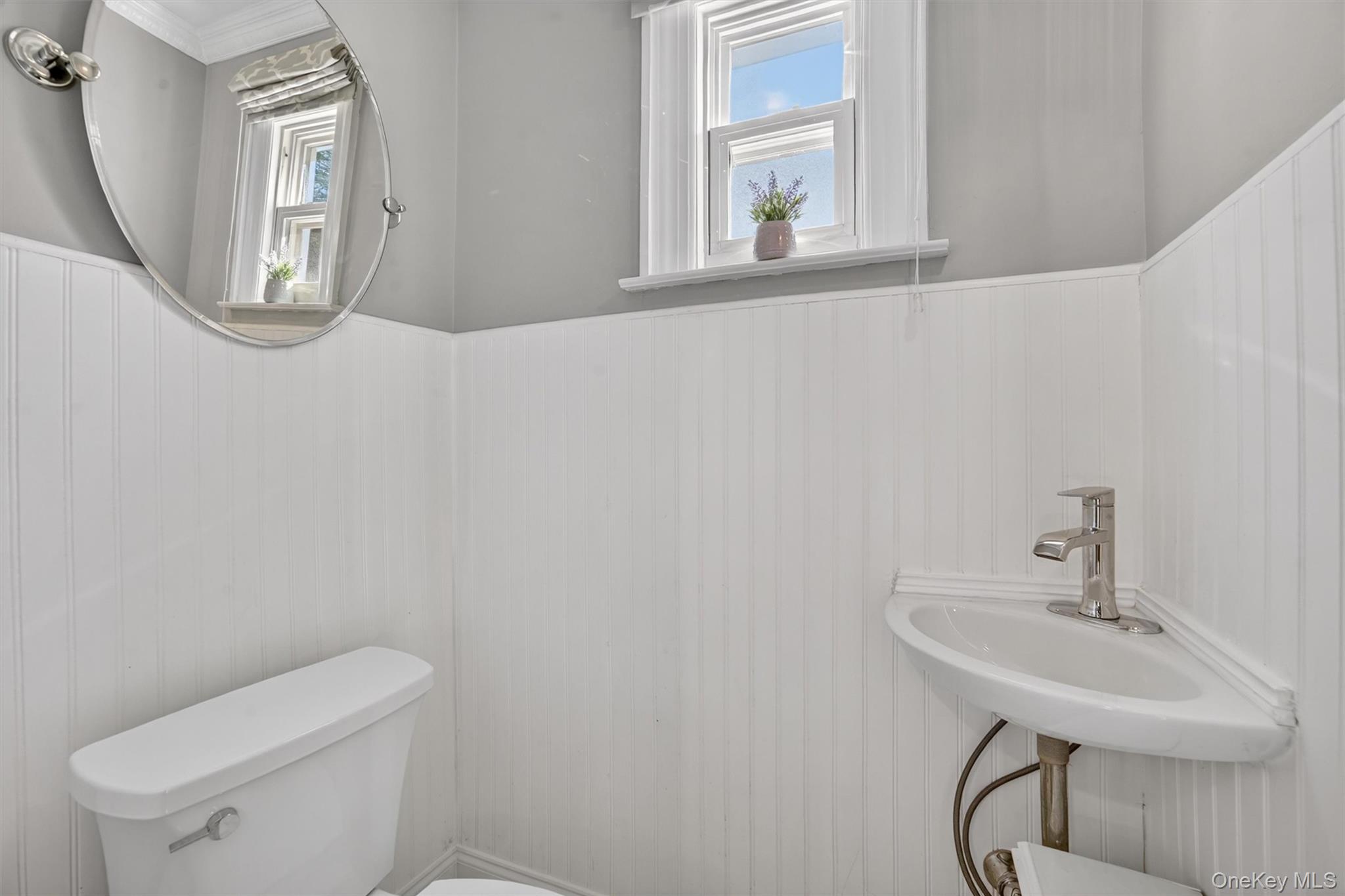 404 Bronxville Road Bronxville, NY 10708 - Photo 23 of 43 a bathroom with a toilet a sink and mirror