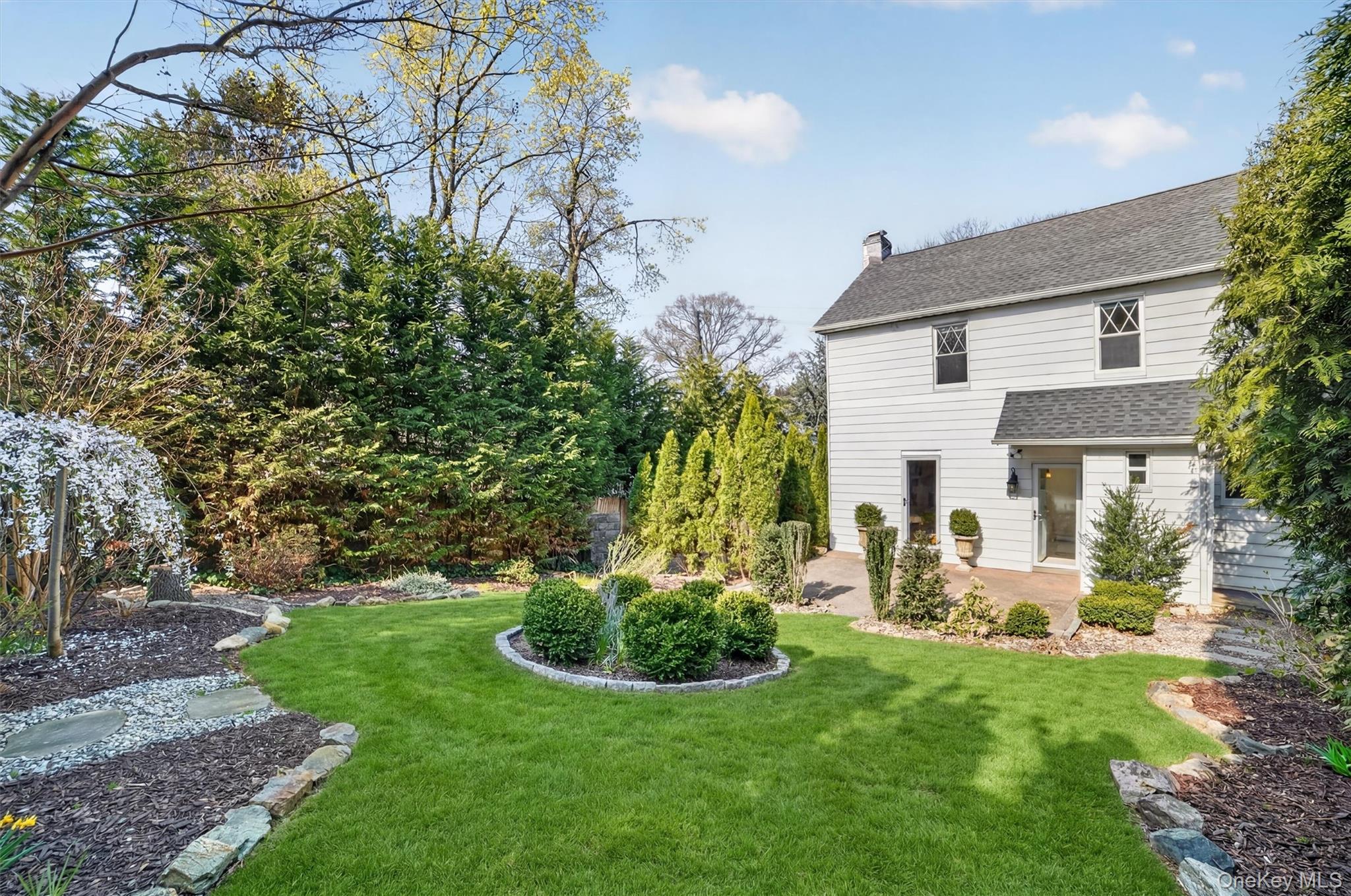 404 Bronxville Road Bronxville, NY 10708 - Photo 37 of 43 a view of a house with a yard and potted plants
