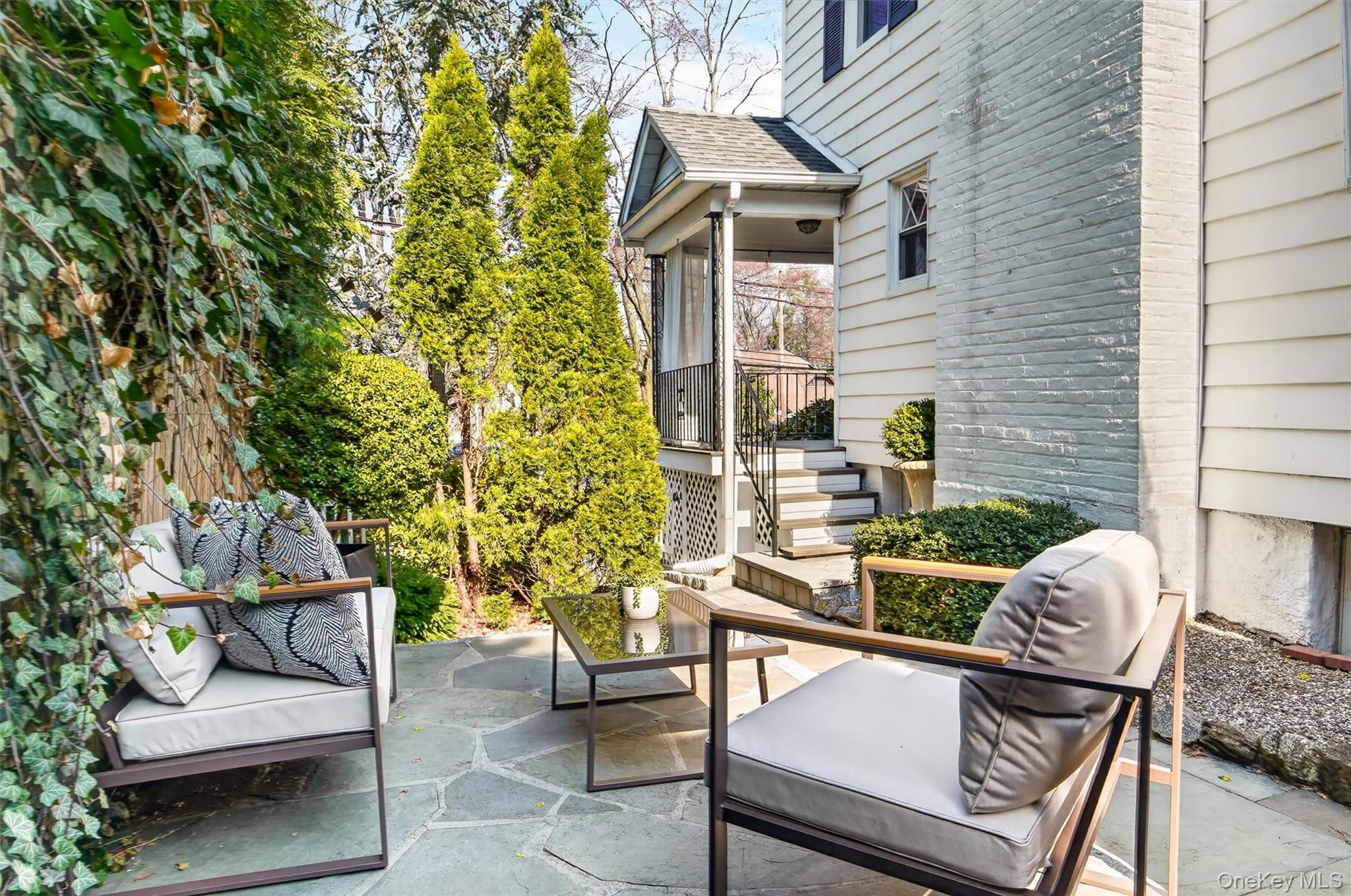404 Bronxville Road Bronxville, NY 10708 - Photo 39 of 43 a view of a patio with couches table and chairs and potted plants