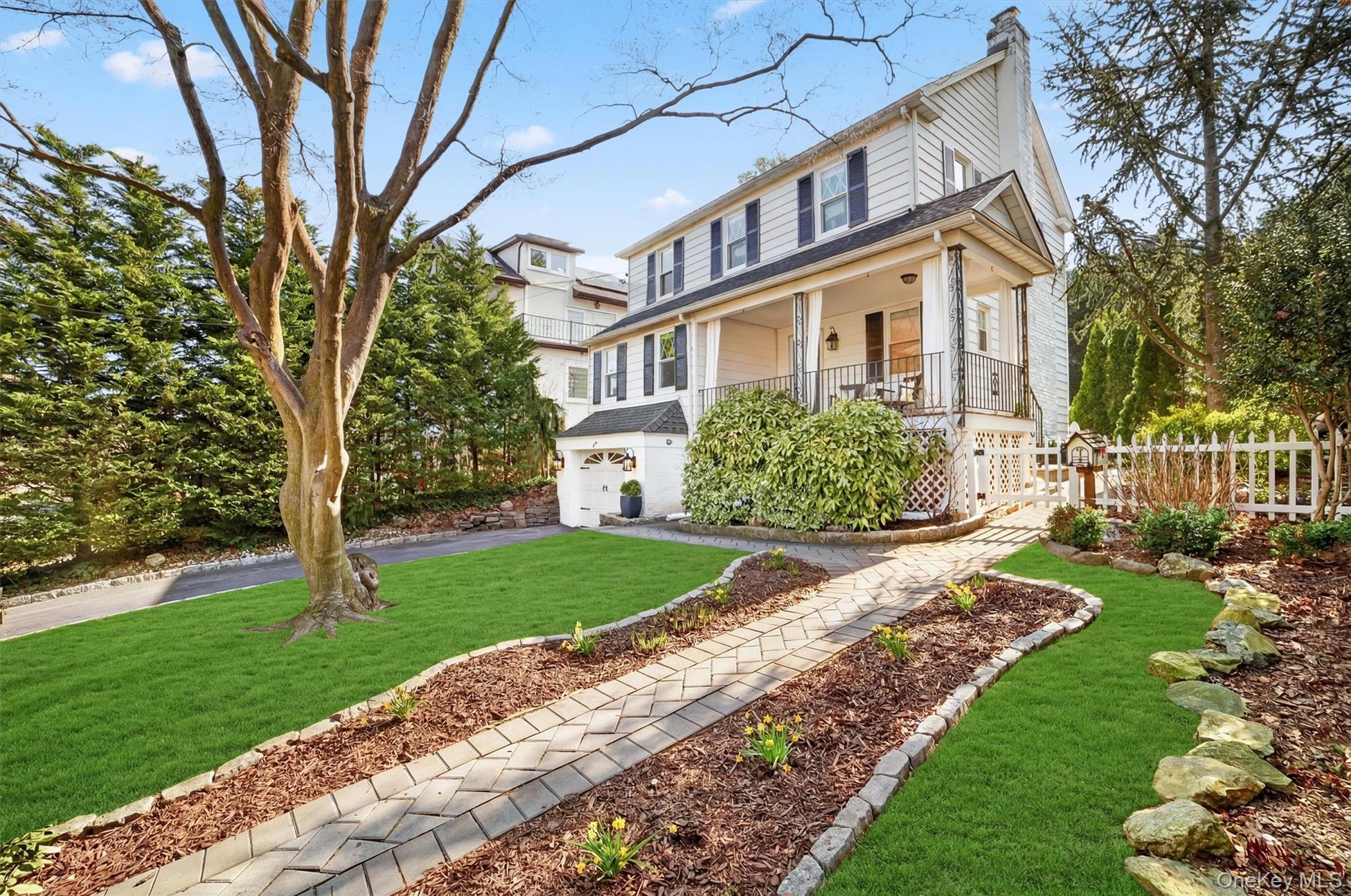 404 Bronxville Road Bronxville, NY 10708 - Photo 4 of 43 a front view of a house with garden