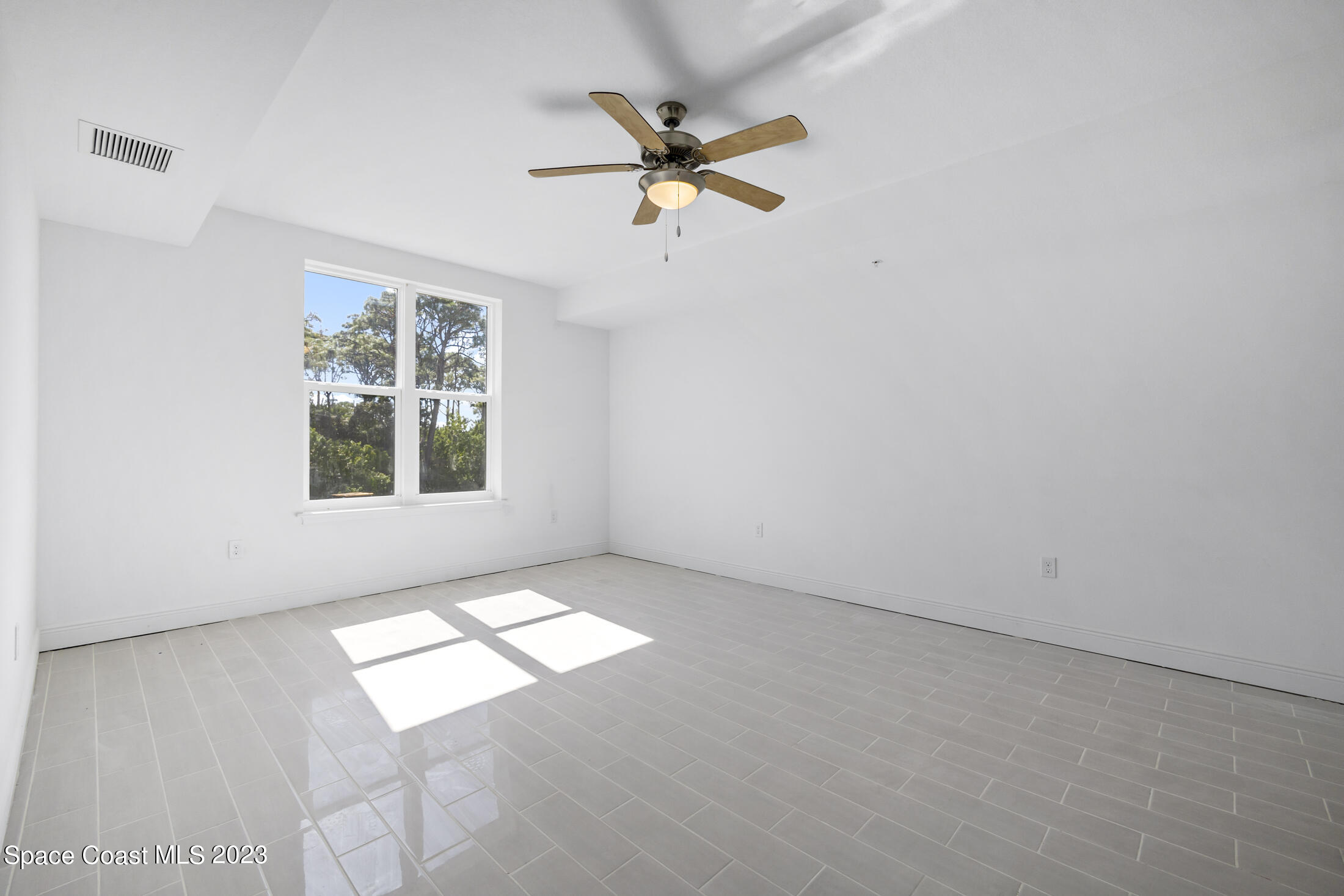 735 Pilot Lane, Unit 313 Merritt Island, FL 32952 - Photo 14 of 20 an empty room with windows and fan