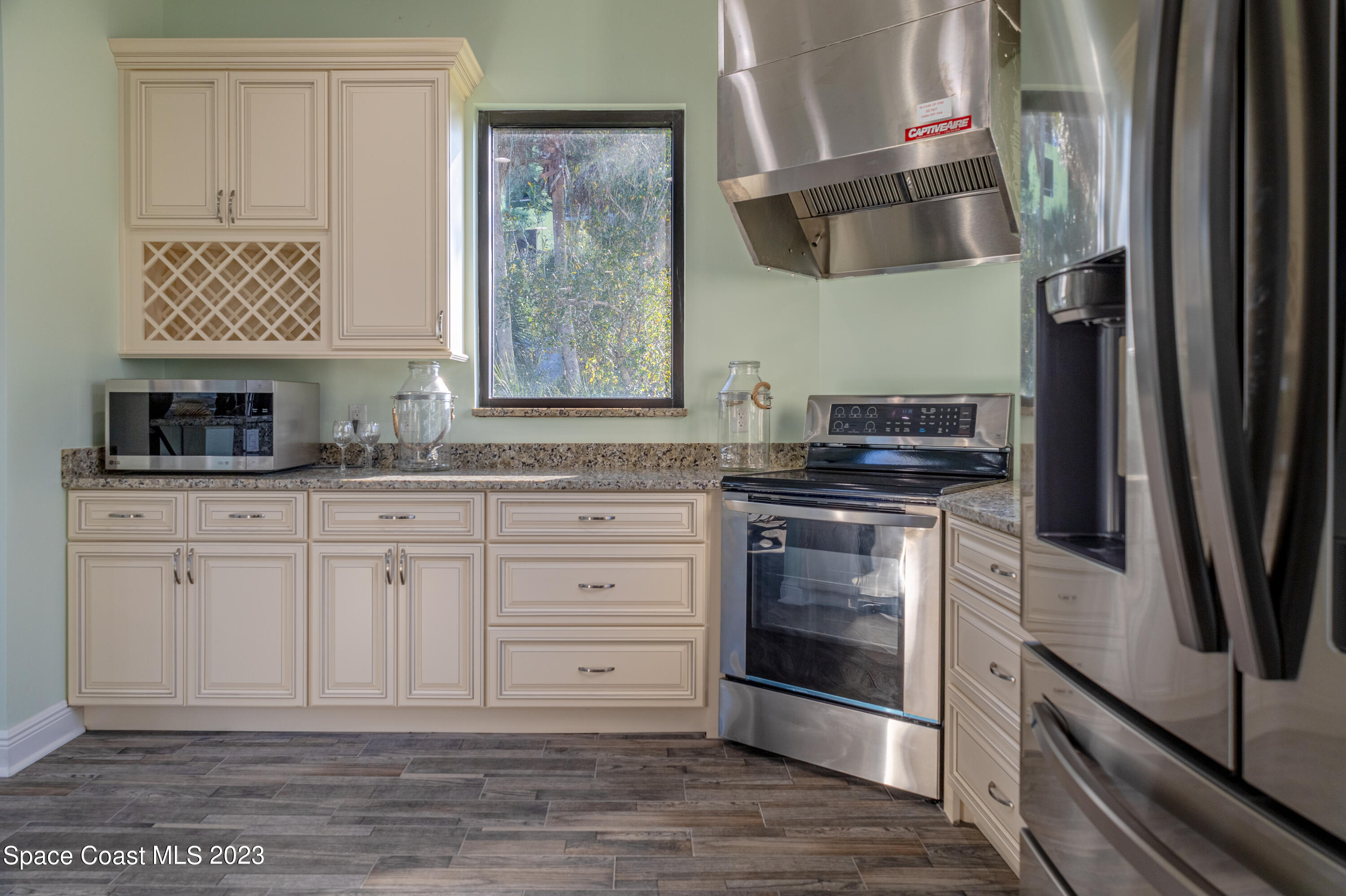 735 Pilot Lane, Unit 313 Merritt Island, FL 32952 - Photo 19 of 20 a kitchen with granite countertop a sink and a stove top oven