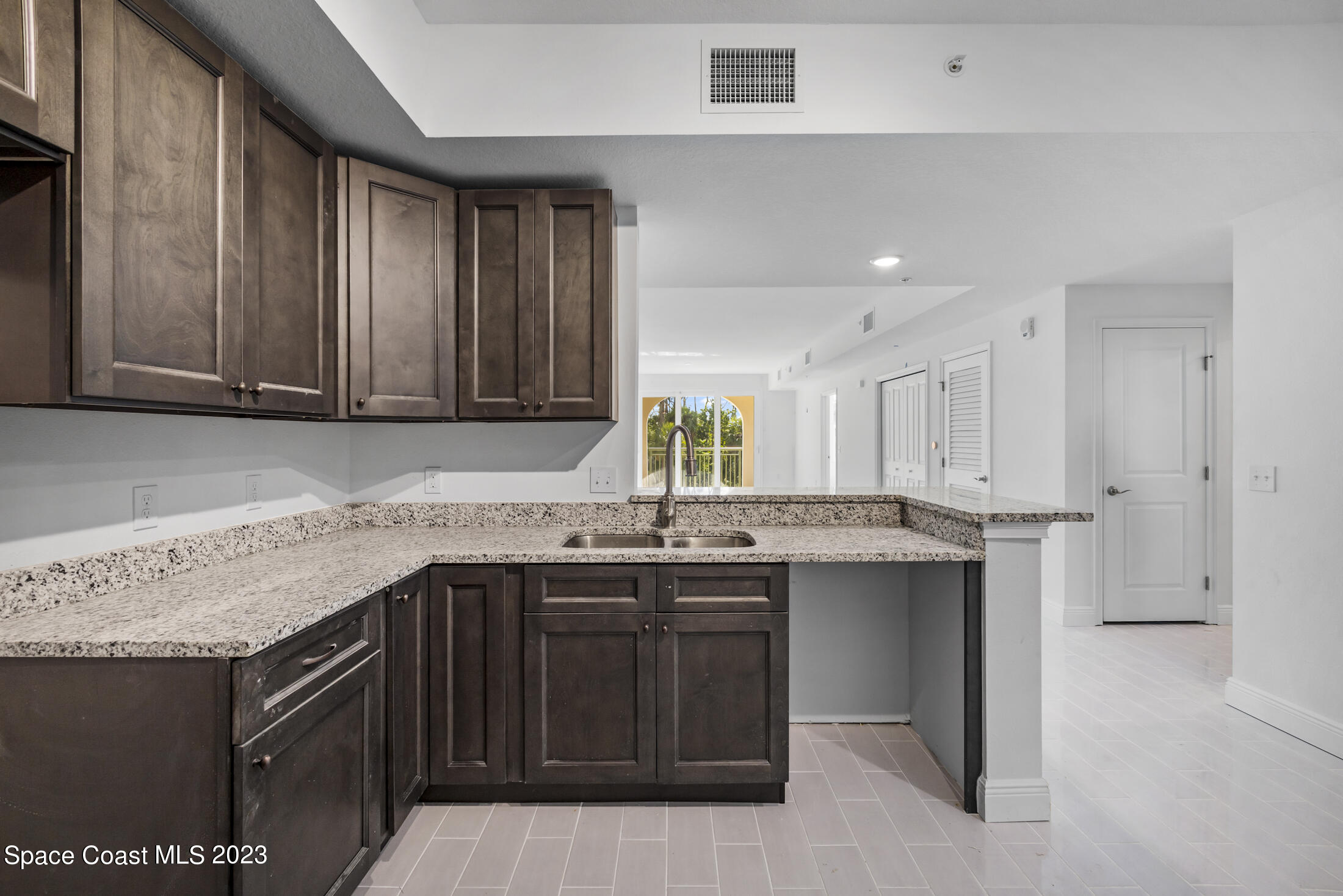 735 Pilot Lane, Unit 313 Merritt Island, FL 32952 - Photo 6 of 20 a kitchen with a sink stove and cabinets