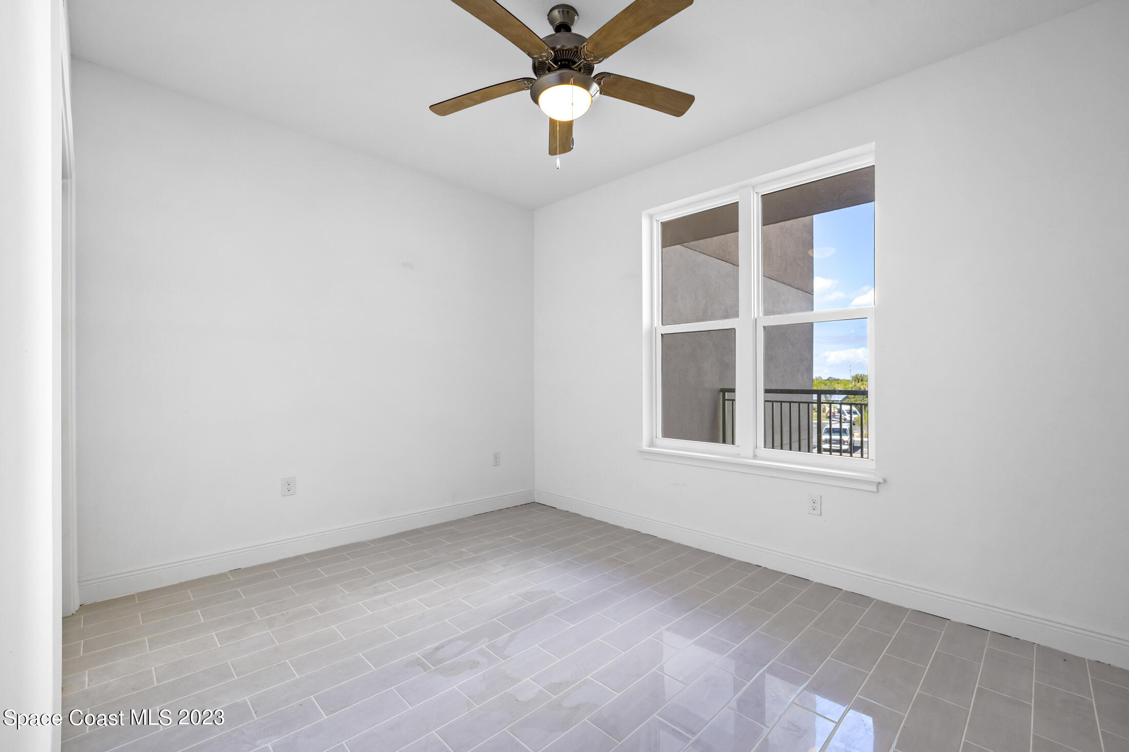 735 Pilot Lane, Unit 313 Merritt Island, FL 32952 - Photo 8 of 20 an empty room with a window and a fan