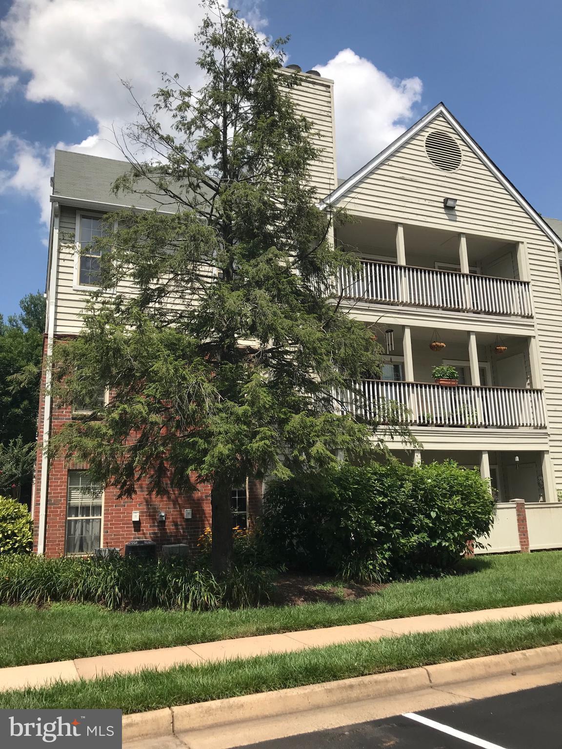 12151 Penderview Lane, Unit 2038 Fairfax, VA 22033 - Photo 1 of 18 a front view of a house with a yard and trees