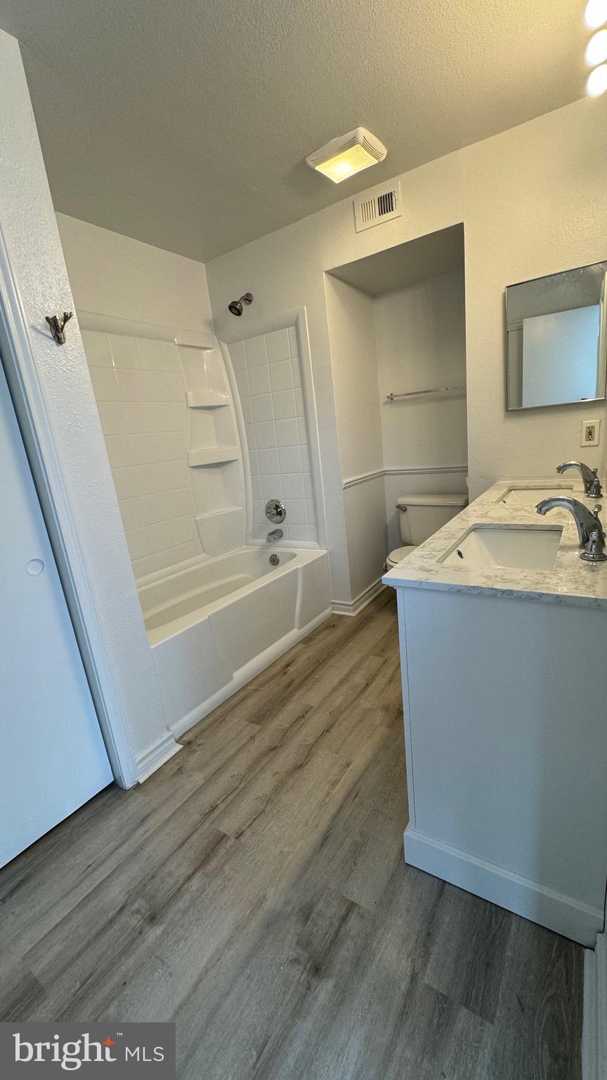 12151 Penderview Lane, Unit 2038 Fairfax, VA 22033 - Photo 12 of 18 a bathroom with a sink a toilet and shower