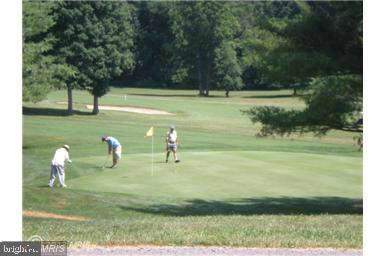 12151 Penderview Lane, Unit 2038 Fairfax, VA 22033 - Photo 17 of 18 a view of a golf course with chairs