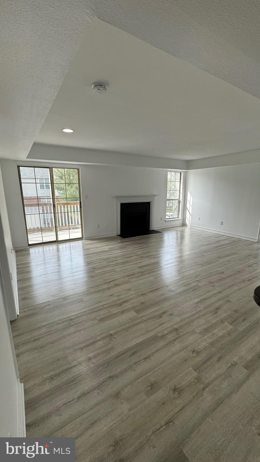 12151 Penderview Lane, Unit 2038 Fairfax, VA 22033 - Photo 10 of 18 a view of an empty room with window and wooden floor