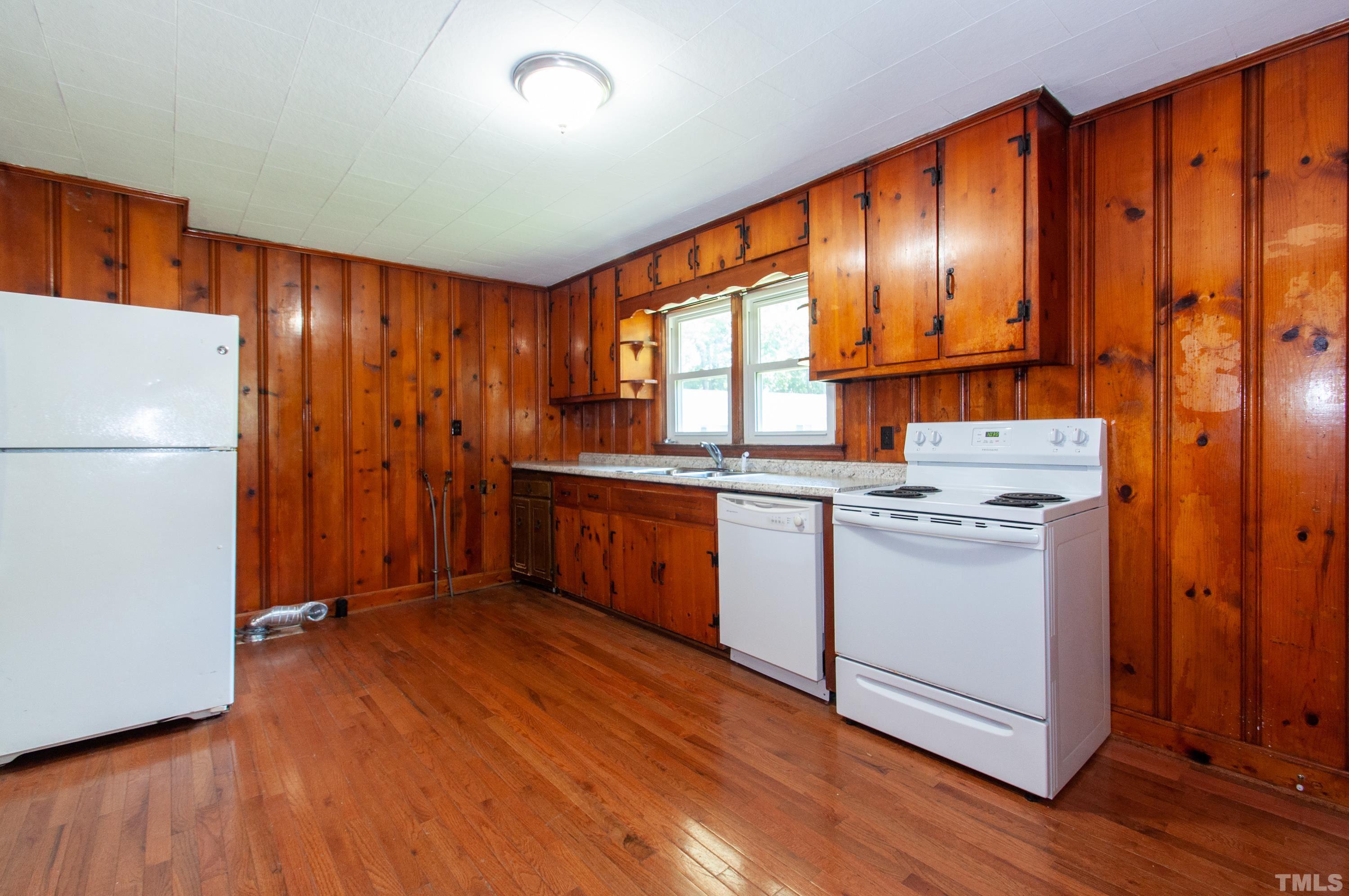 5111 Old Stage Road Raleigh, NC 27603 - Photo 14 of 29 a kitchen with granite countertop wooden floors and white stainless steel appliances