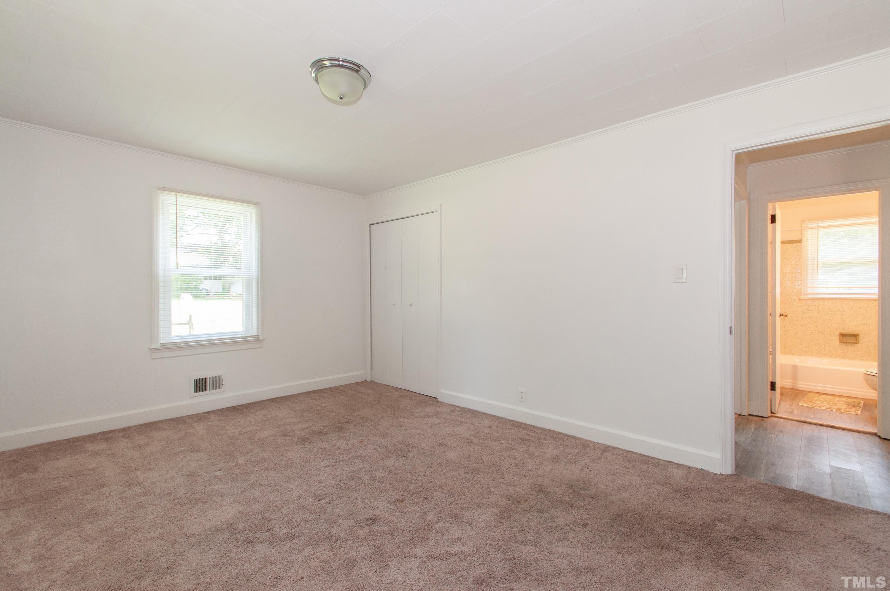 5111 Old Stage Road Raleigh, NC 27603 - Photo 17 of 29 an empty room with a window and wooden floor