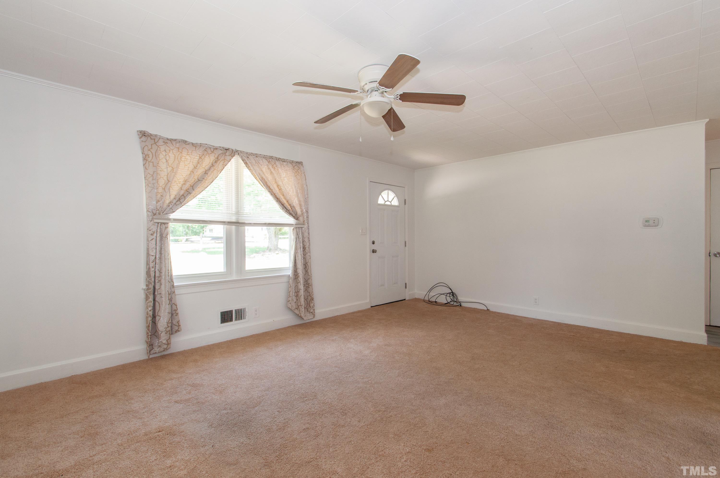 5111 Old Stage Road Raleigh, NC 27603 - Photo 10 of 29 an empty room with windows and fan view