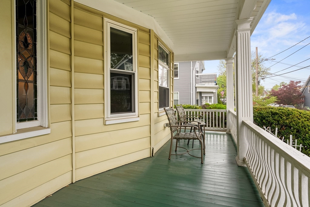 17 Commonwealth Road, Unit 1 Watertown, MA 02472 - Photo 2 of 6 a view of a balcony with chair and wooden floor