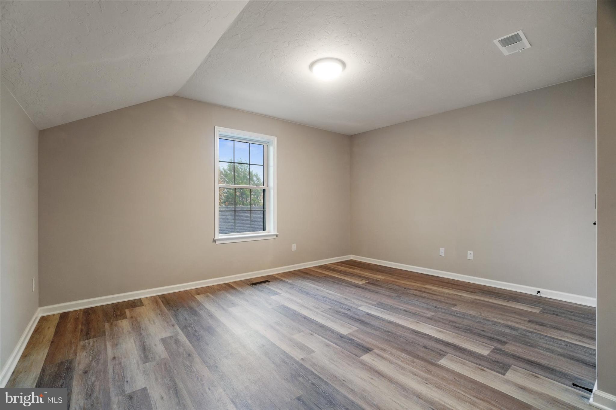 5 Fuhrman Mill Road Hanover, PA 17331 - Photo 10 of 16 a view of an empty room with wooden floor and a window