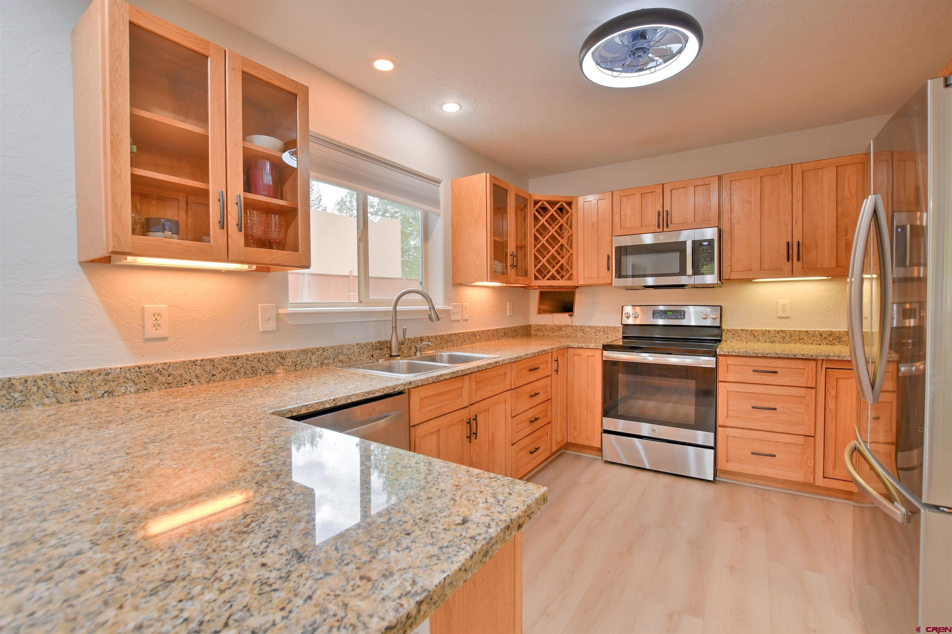 602 Chipeta Drive Ridgway, CO 81432 - Photo 5 of 41 a kitchen with kitchen island granite countertop a stove top oven a sink and dishwasher with wooden floor