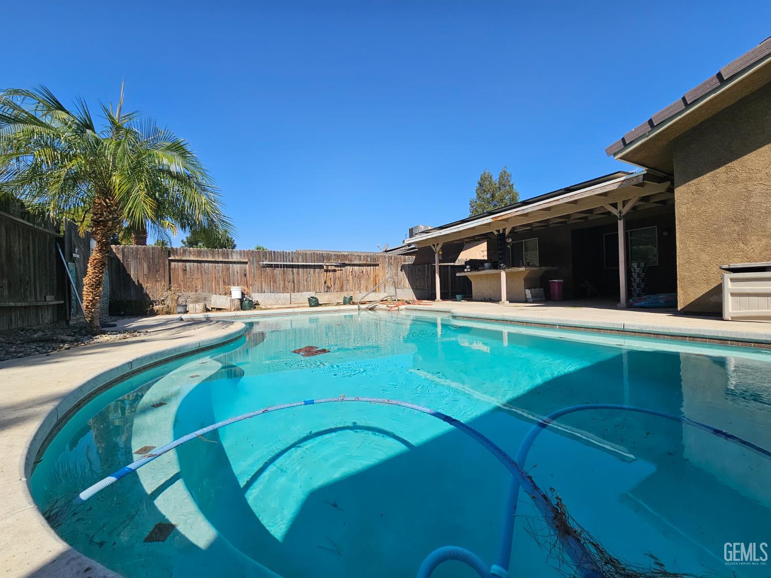 Undisclosed Address Bakersfield, CA 93308 - Photo 4 of 11 a view of a house with a swimming pool