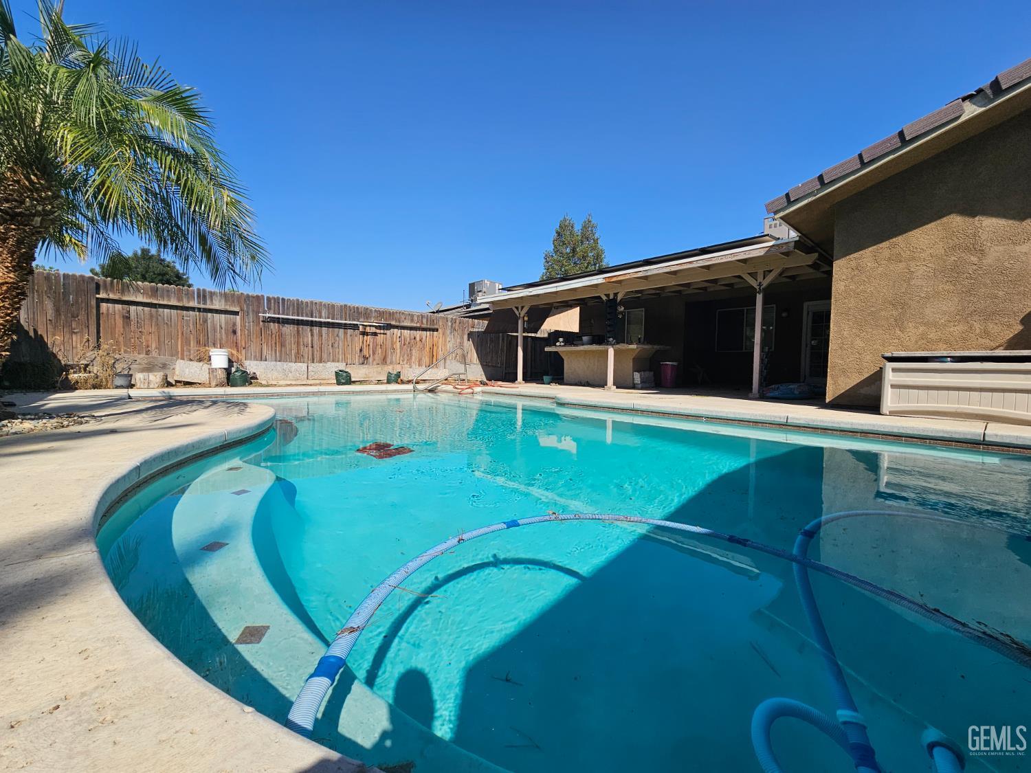 Undisclosed Address Bakersfield, CA 93308 - Photo 5 of 11 a view of a swimming pool with an outdoor seating