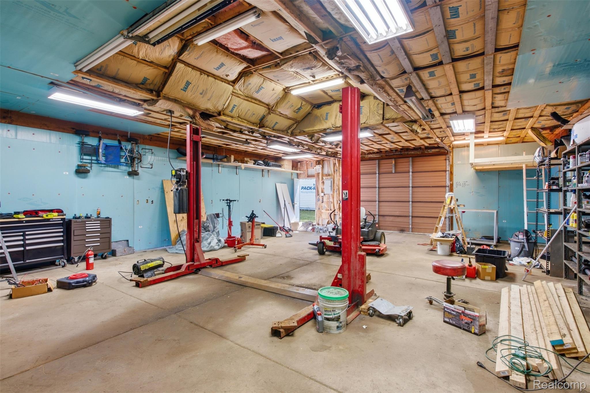9200 Hickory Ridge Road Holly, MI 48442 - Photo 33 of 33 Spacious utility building featuring concrete flooring, exposed wood beam ceiling, and a large roll-up door