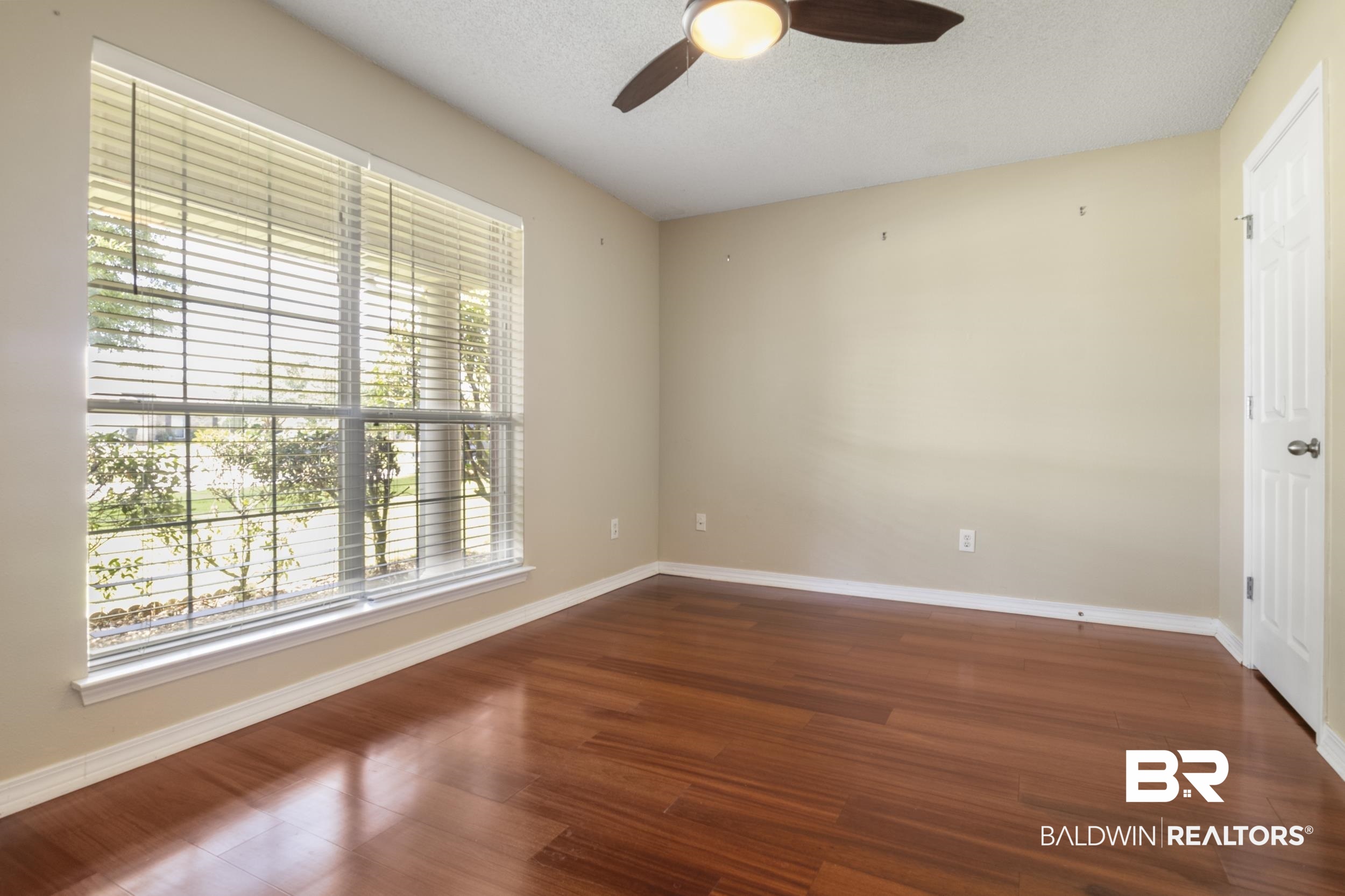 9610 Watkins Drive Fairhope, AL 36532 - Photo 13 of 26 Spare room featuring ceiling fan and dark wood-type flooring