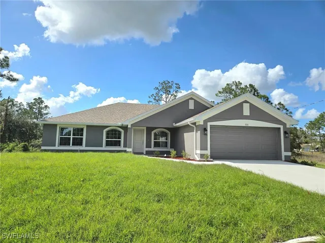 a front view of house with yard and green space