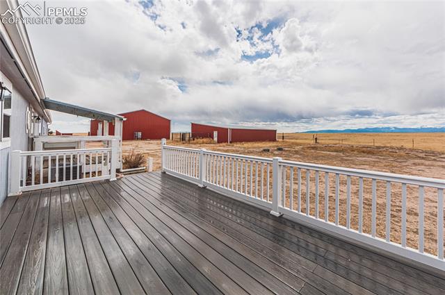 22885 Handle Road Calhan, CO 80808 - Photo 6 of 38 Deck with an outdoor structure and a pole building