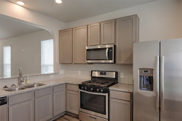a kitchen with a sink stove and microwave