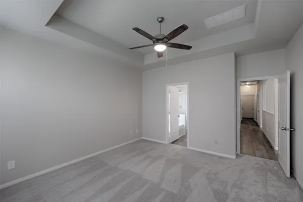 an empty room with closet and a chandelier fan