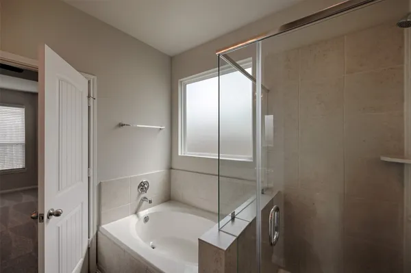 a bathroom with a bathtub and a shower