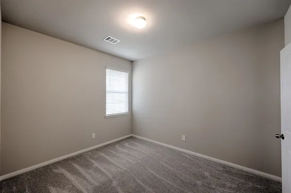 an empty room with a empty space and windows