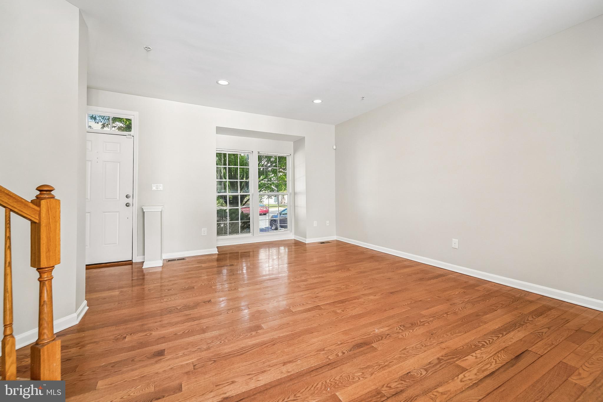 1461 Pangbourne Way Hanover, MD 21076 - Photo 7 of 51 a view of an empty room with wooden floor and a window