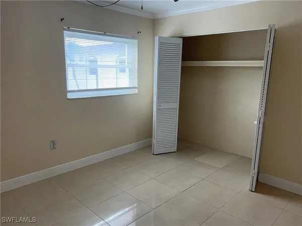 a view of an empty room with closet area