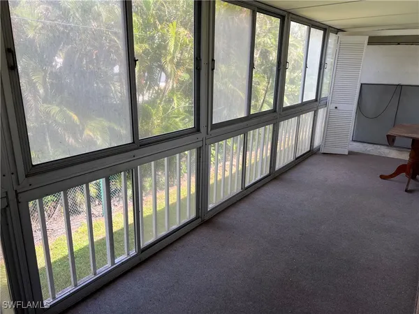 a view of an empty room with windows